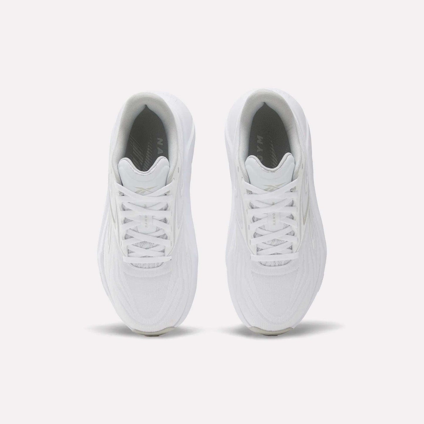 The Reebok Women's Nano Gym 2.0 Training Shoes are shown from above, featuring white laces and textured uppers against a plain white background—ideal for versatile workouts.