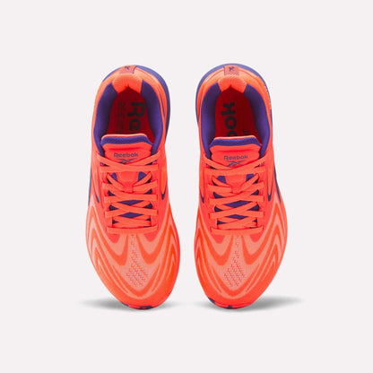 Top view of Women's Nano X5 Edge Training Shoes by Reebok in bright orange and purple with wavy patterns, purple lining, and orange laces—ideal for HIIT classes—shown side by side on a plain white background.