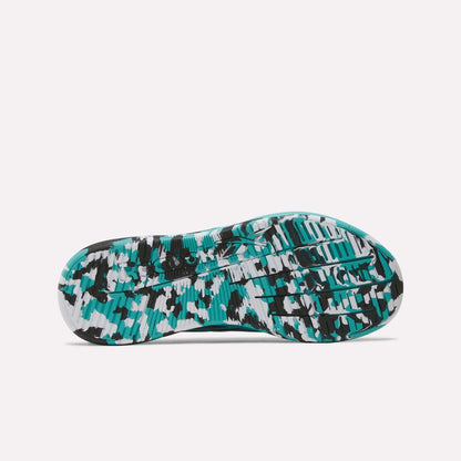 The image displays the bottom view of the Reebok Women's Nano X5 Edge Training Shoes sole, featuring a colorful teal, black, gray, and white pattern with textured grooves and geometric shapes for optimal HIIT or training traction.