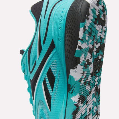A close-up of the Reebok Women's Nano X5 Edge Training Shoes in turquoise and black, featuring side branding, mesh texture, and a patterned sole with white, black, and turquoise accents—perfect for HIIT classes.