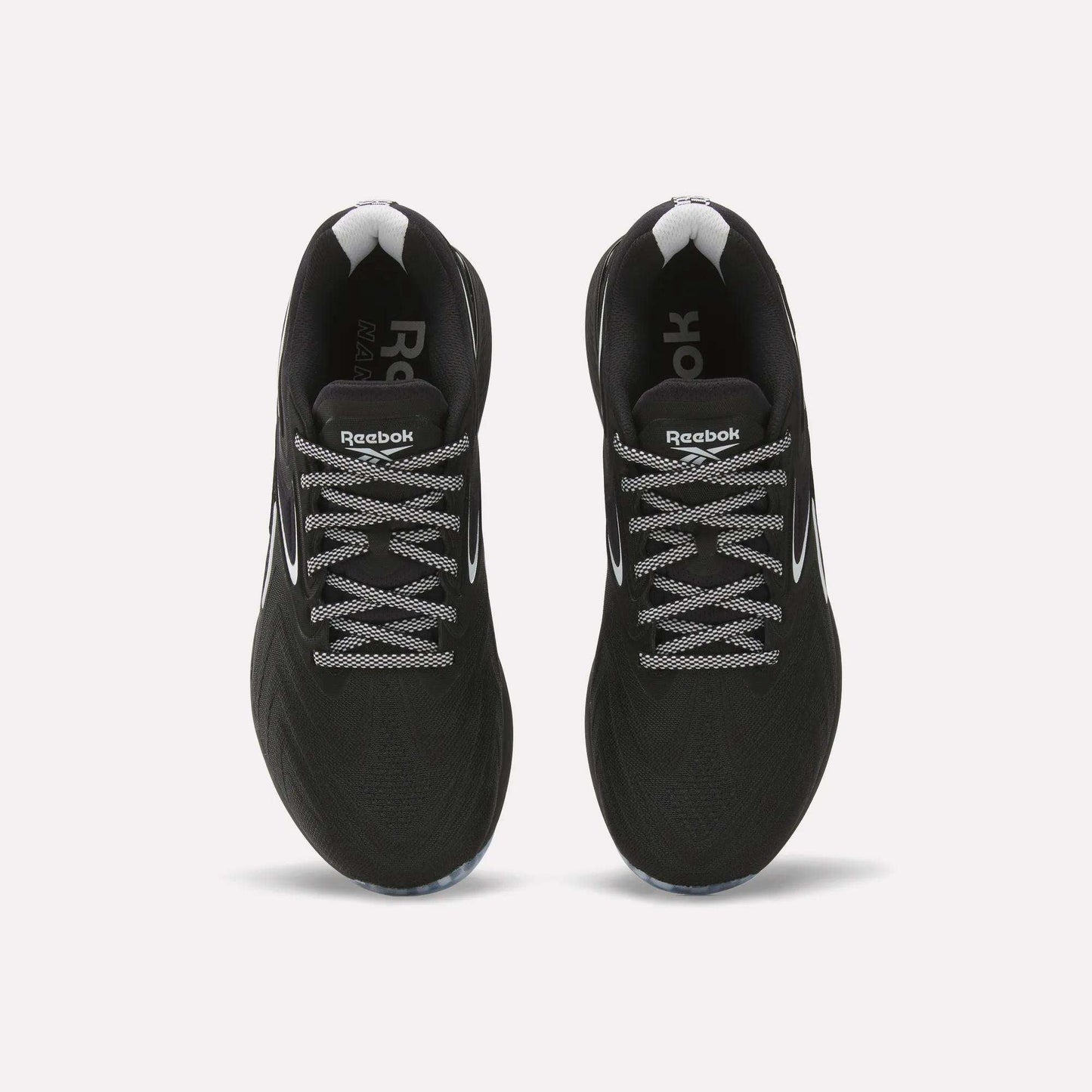 Top view of Reebok Nano X5 Edge Training Shoes—black with white accents and patterned laces—side by side on a light background, built for peak performance.