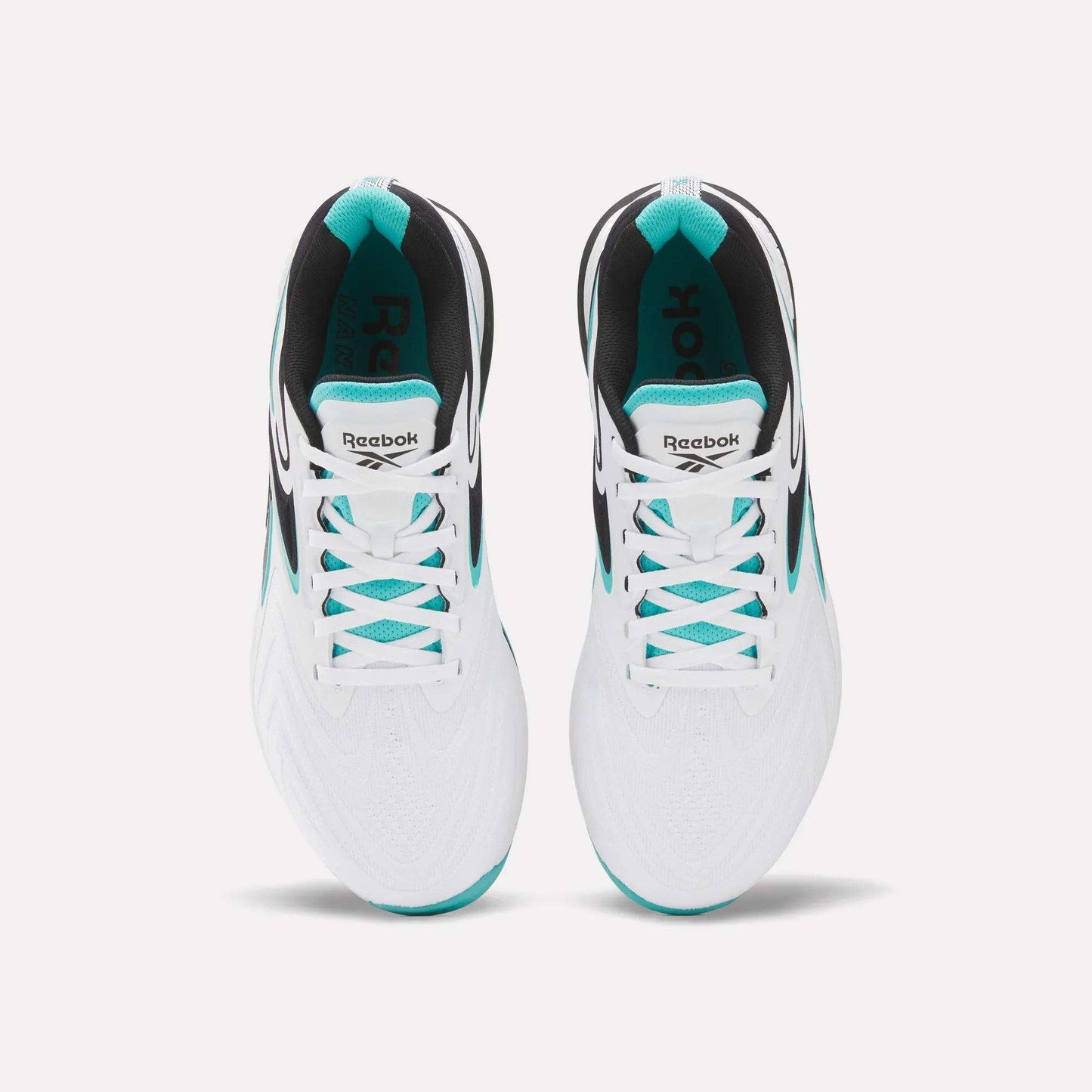 Top view of Reebok Nano X5 Edge Training Shoes in white with teal and black accents, featuring the Reebok logo on the tongue. Placed side by side—perfect for high-performance workouts.