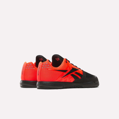 The Reebok Men's Nano 2.0 Training Shoes feature bright orange uppers, black soles, black laces, and bold black logos—perfect for functional fitness—displayed against a plain white background.