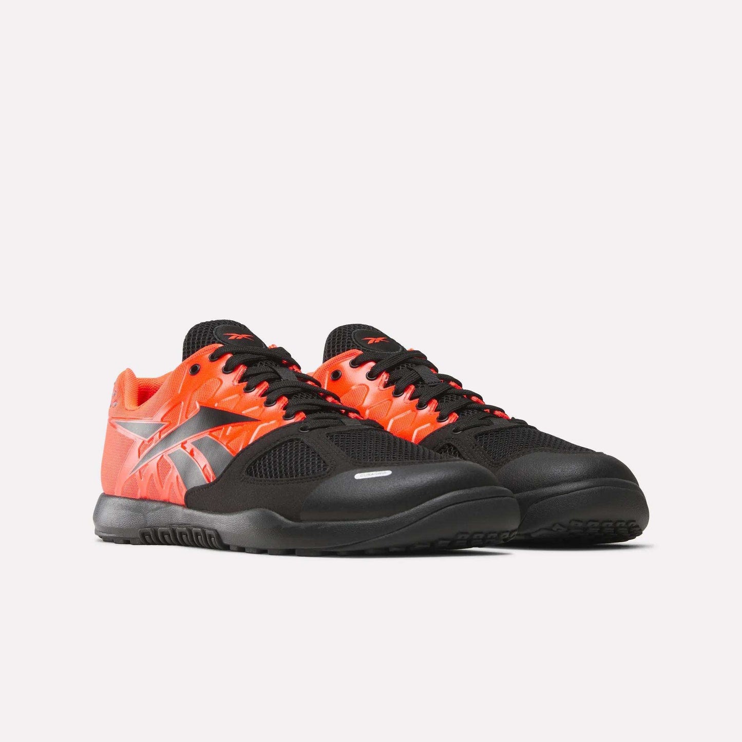 Reebok Men's Nano 2.0 Training Shoes with black mesh toes and laces, vivid red-orange sides, silver logo, and functional fitness style—shown on a plain white background.