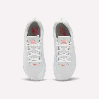 A pair of white Reebok Nano Zero Training Shoes, shown from above on a plain white background, feature red Reebok branding on the tongue and insole, white laces, a breathable mesh upper, and a zero-drop design.