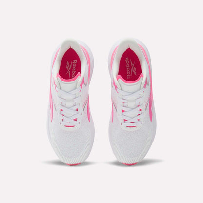 A pair of Women's Viva Speed Shoes by Reebok in white with pink accents, shown from above on a white background. These breathable shoes feature white laces, a cushioned midsole for all-day comfort, and a pink Reebok logo on the insoles.