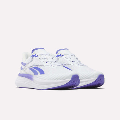 Introducing the Reebok Women's Viva Speed Shoes: a stylish pair of white athletic sneakers highlighted with vibrant purple accents on the sole, logo, and detailing. Featuring a cushioned design and breathable mesh texture for enhanced comfort, these sneakers are ideal for your active lifestyle. Shown here against a plain white background.