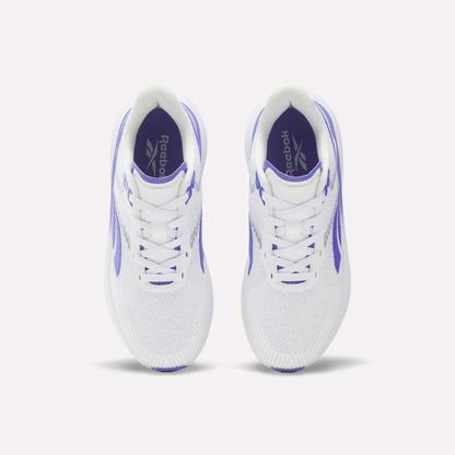 Top view of a pair of Reebok Women's Viva Speed Shoes featuring purple accents and Reebok logos on the insoles, placed side by side on a plain white background. These cushioned sneakers are crafted for comfort and style, making them perfect for active lifestyles.