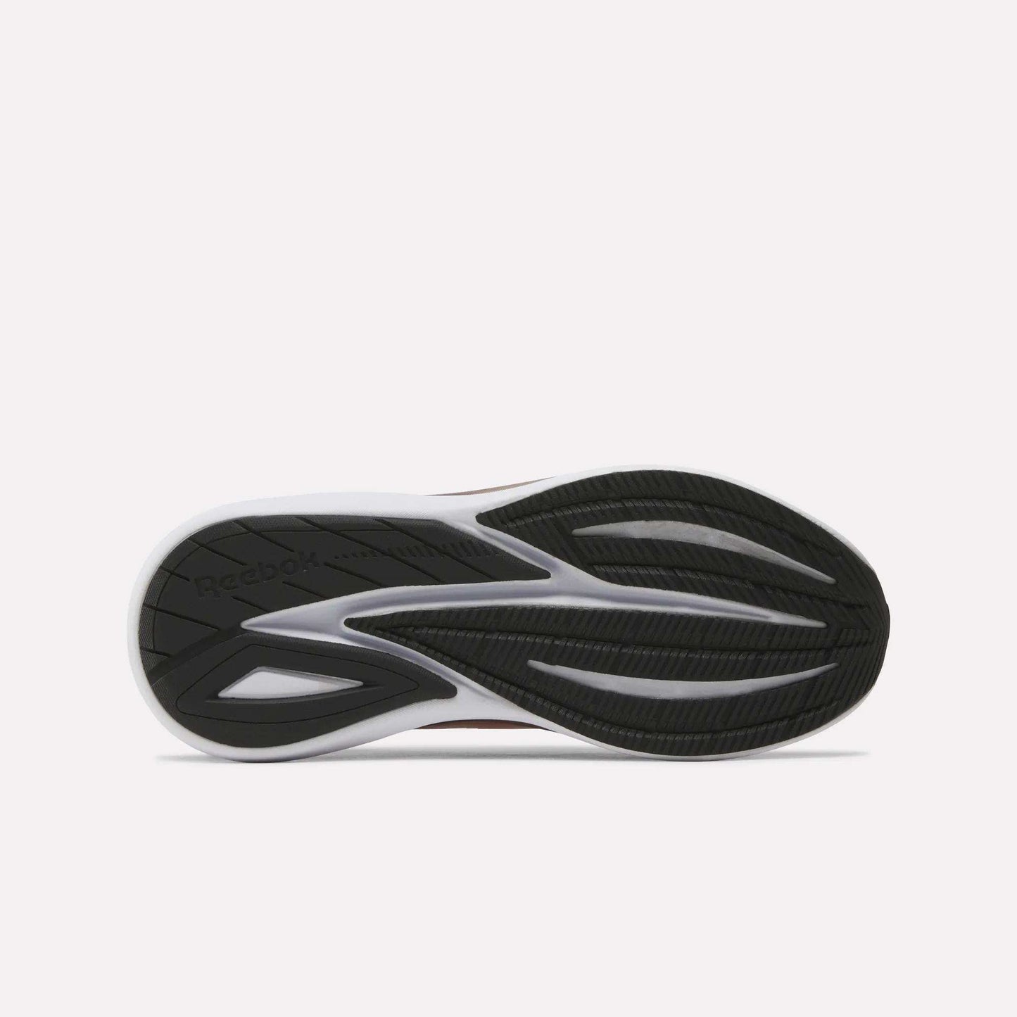 The image displays the black and white rubber outsole of the Women's Viva Speed Shoes by Reebok, showcasing grooves and textured patterns that provide traction. Designed to enhance grip in cushioned running footwear, the outsole also features an embossed Reebok logo on the left side.