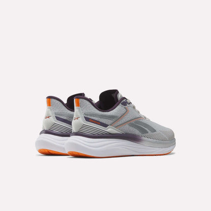 A pair of Women's Viva Speed Shoes by Reebok in gray and white, featuring purple and orange accents, designed with cushioning for enhanced comfort, shown from the back and side against a plain white background.