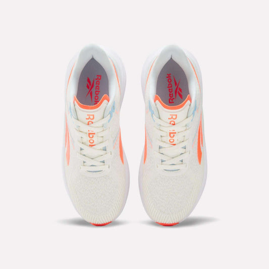 Top view of a pair of Women's Viva Speed Shoes by Reebok in white with orange accents and light blue details, displayed side by side on a plain white background. These breathable shoes feature the Reebok logo on the insoles for added style and comfort.
