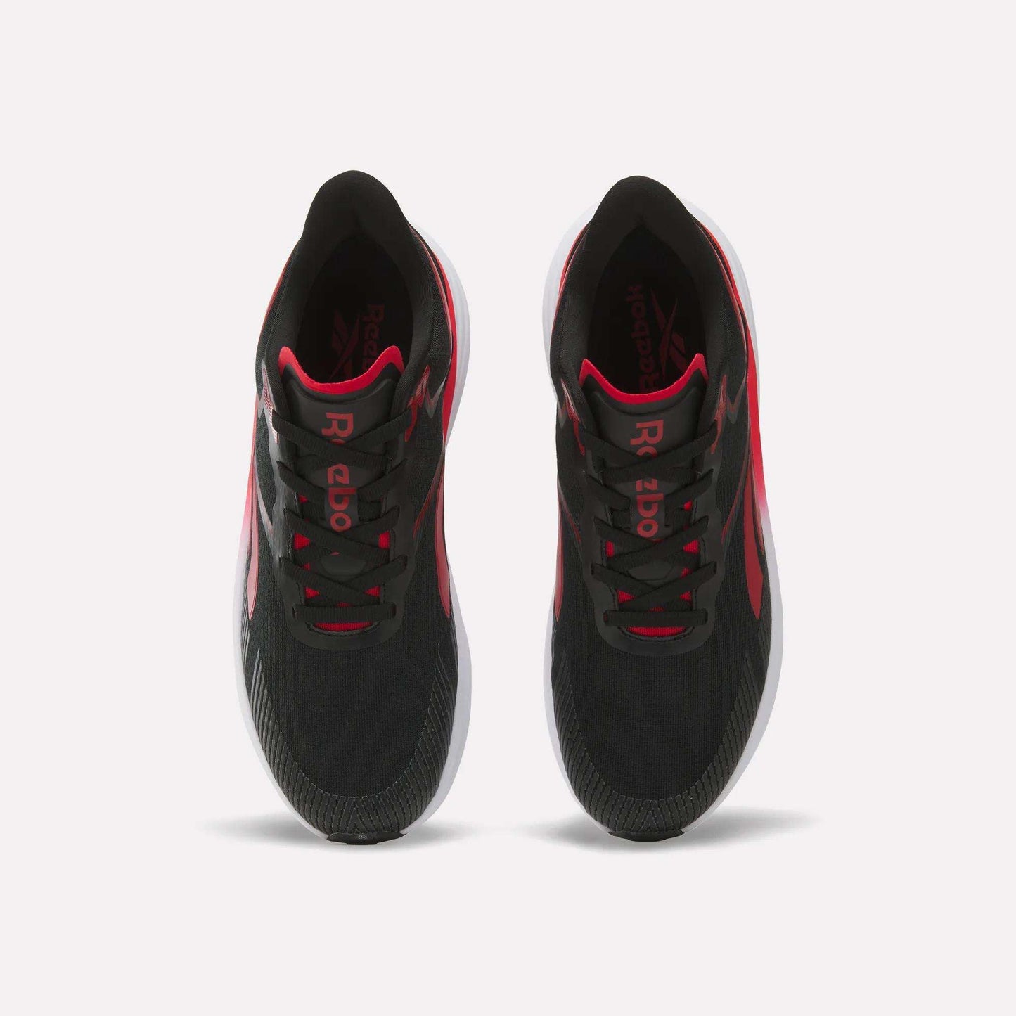 A pair of Men's Viva Speed Shoes by Reebok in black with red accents and white soles, designed as cushioned running shoes for maximum comfort, shown from above against a plain white background.