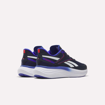 The Reebok Men's Viva Speed Shoes feature a black and white athletic design with striking blue and purple accents, thick white soles, and bold red highlights. Positioned on a light background facing away from each other, these sneakers provide breathable comfort and cushioned support, making them ideal for everyday wear.