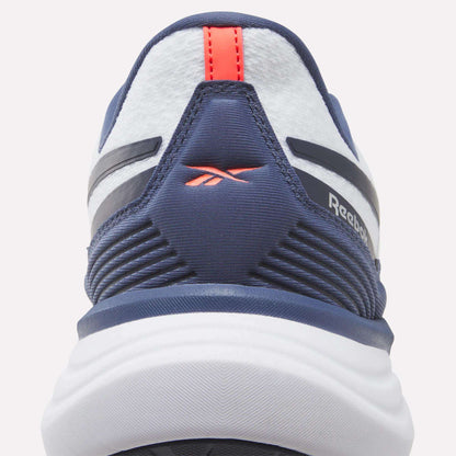 Close-up of the heel of a navy and white Reebok Men's Viva Speed Shoe, showcasing a red logo and red pull tab with textured and striped design details. These cushioned Men's Viva Speed Shoes provide both comfort and style.