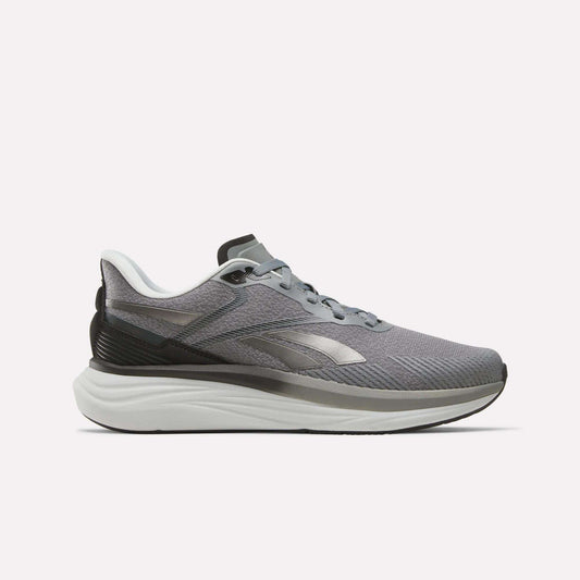 The Reebok Men's Viva Speed Shoes in Grey 4/Grey 5/Black feature a sleek athletic design with black and white accents, a cushioned white sole for enhanced comfort, and a convenient lace-up closure. These breathable men's running shoes are presented against a plain white background.
