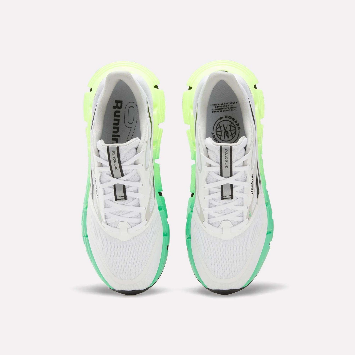 A top view of Reebok Men's FloatZig 2 Running Shoes in white with light green and neon yellow accents, Superfloat+ cushioning, black soles, and branding on the tongues and insoles, set against a plain white background.
