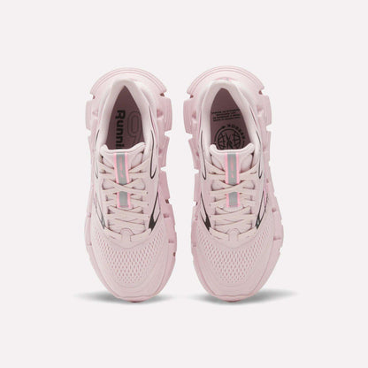 A pair of Women's FloatZig 2 Running Shoes by Reebok in light pink, seen from above with mesh uppers, chunky soles with Superfloat+ cushioning, and light blue and pink striped laces, displayed on a white background.
