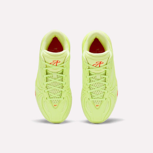 A top-down view of Reebok Angel Reese 1 Shoes - Big Kids in neon yellow-green, featuring textured laces and red logo details on the tongue, shown against a plain light background.