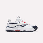 The Reebok Nano Golf Shoes are white athletic sneakers with navy blue and red accents, featuring a low-top design, mesh and synthetic upper with lightweight FlexWeave, and the signature Reebok logo on the side.