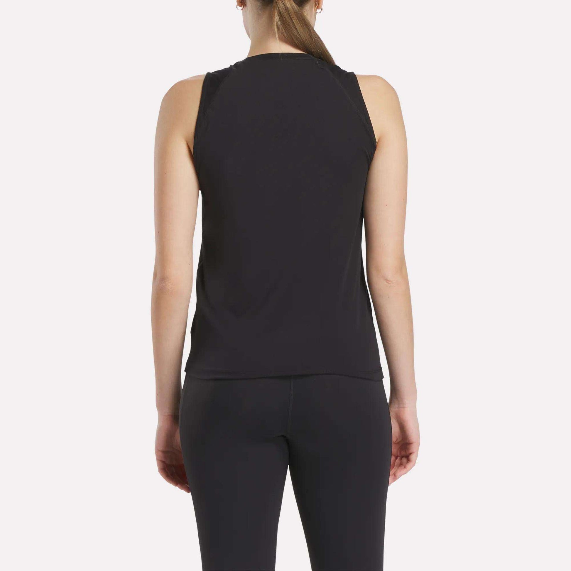 A woman with a ponytail is seen from behind wearing the Women's Reebok x F45 Training Tank Top and black leggings against a plain white background, ideal for F45 Training sessions.