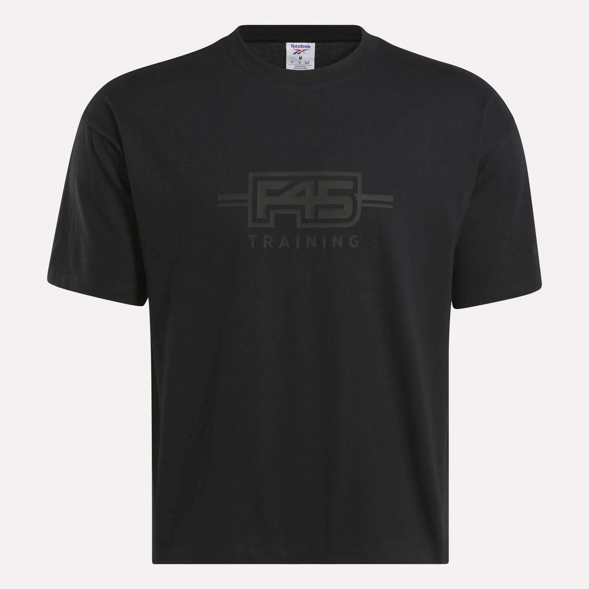 The Reebok x F45 Training Tonal Graphic T-Shirt is a black short-sleeve cotton tee with a subtle F45 TRAINING logo on the front center, shown against a plain white background.