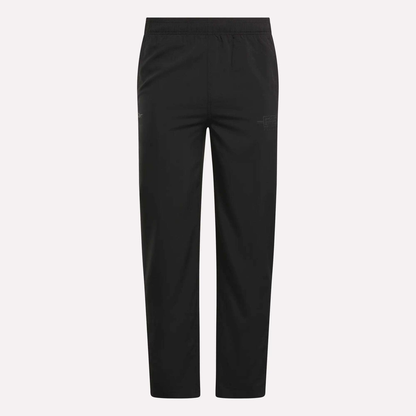 The Men's Reebok x F45 Training Woven Pants feature an elastic waistband, straight legs, and subtle stitching details, designed by Reebok for optimal performance during high-intensity training sessions. They are shown against a plain white background.