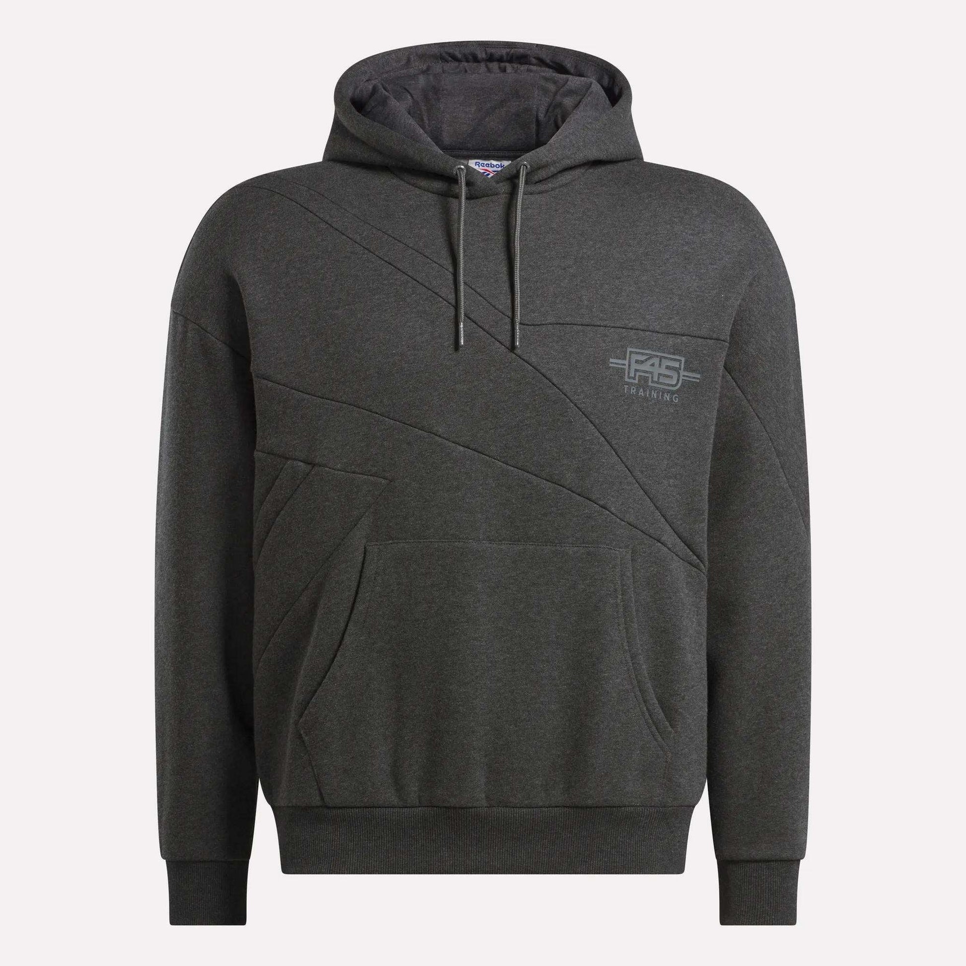 The Men's Reebok x F45 Training Relaxed Hoodie features a dark gray color, front pocket, drawstring hood, subtle diagonal stitching, and a small F45 logo on the left chest—your ideal blend of comfort and style from Reebok.