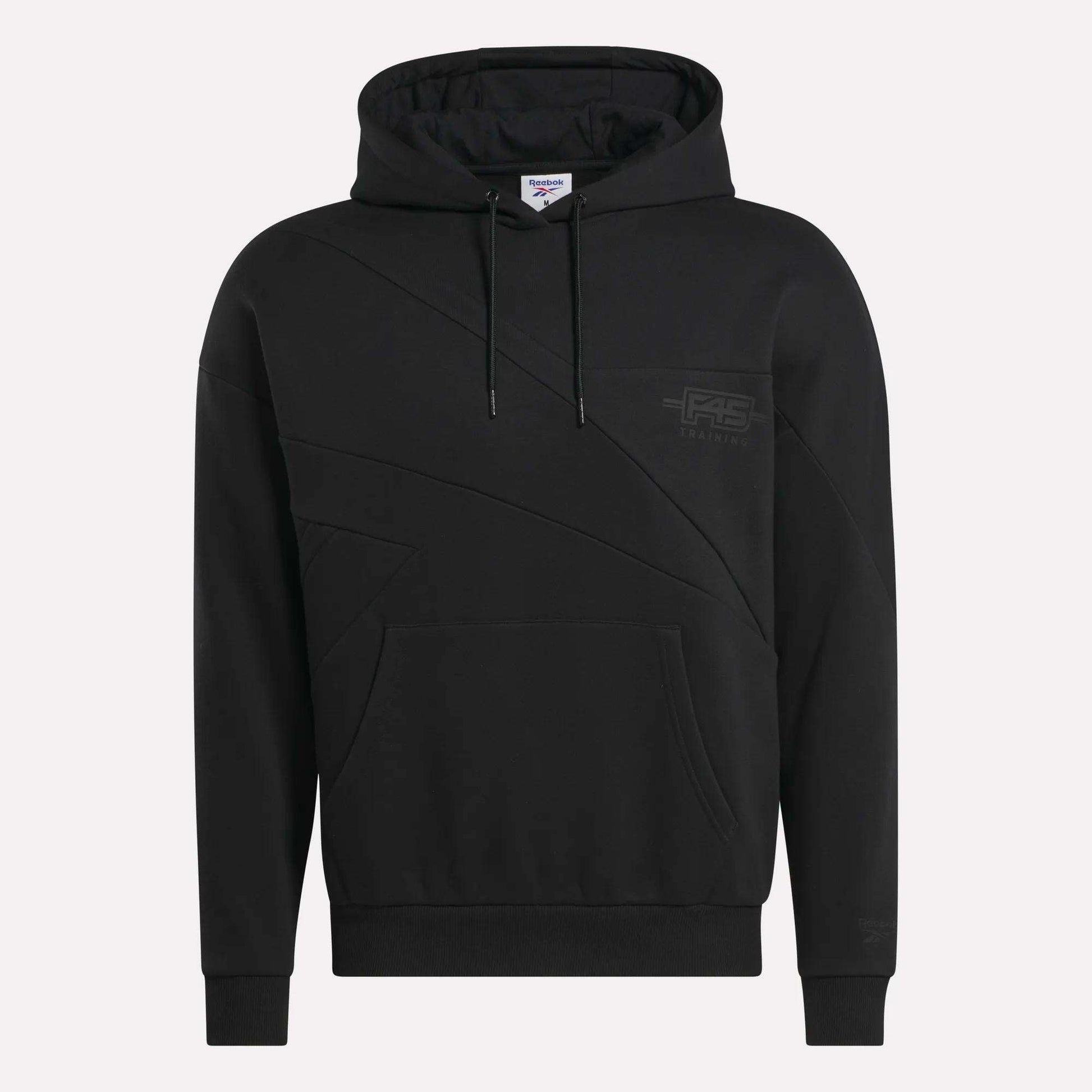 The Men's Reebok x F45 Training Relaxed Hoodie features a black fleece design, front kangaroo pocket, geometric seam details, drawstring hood, and a subtle tonal Reebok logo—ideal for post-F45 Training style and comfort.