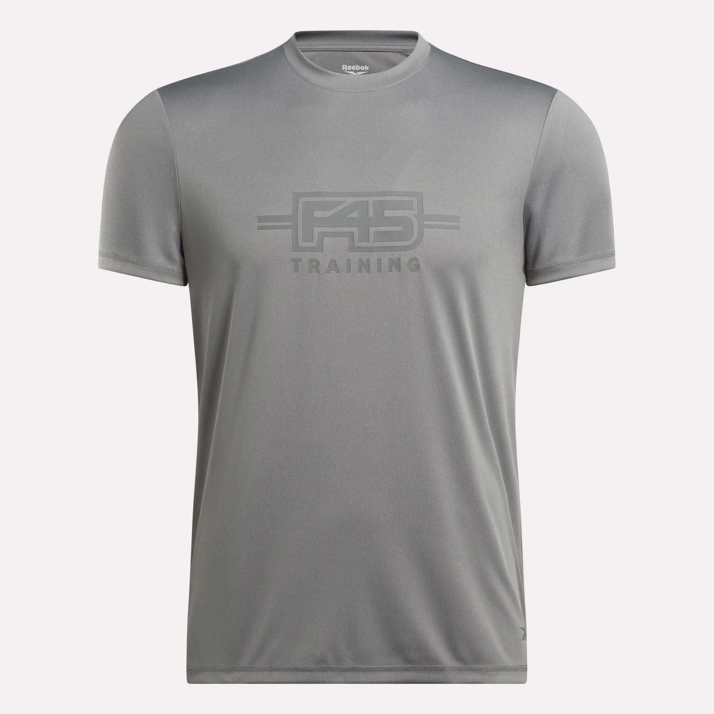 The Men’s Reebok x F45 Training T-Shirt by Reebok is a gray, short-sleeve men’s tee featuring “F45 Training” printed on the front in coordinating gray lettering, made with signature Reebok performance quality, and shown against a plain white background.