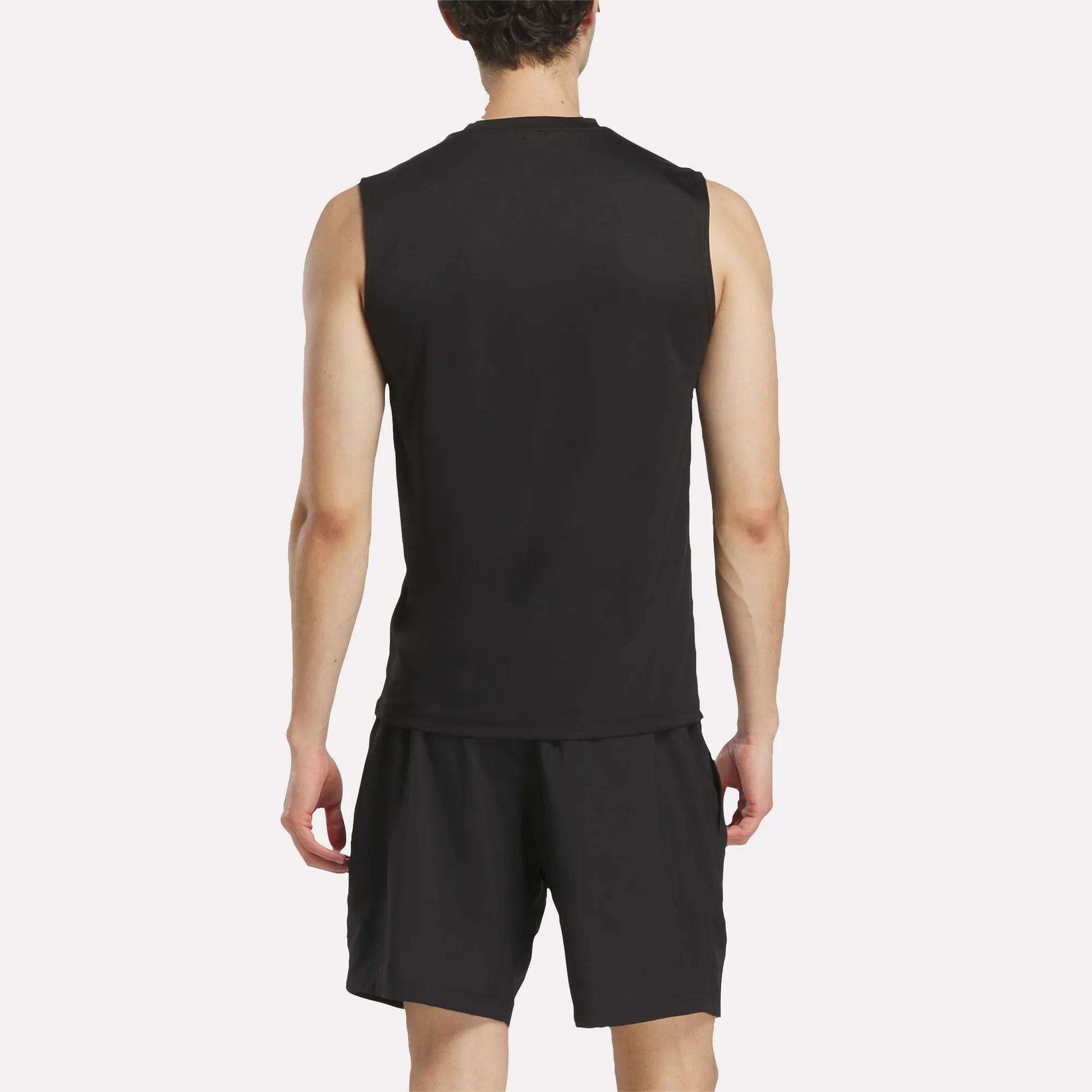 A person wearing a Men's Reebok x F45 Training Tank Top and black shorts stands facing away, displaying the back of their outfit against a plain white background—ideal attire for high-intensity workouts or F45 Training sessions.