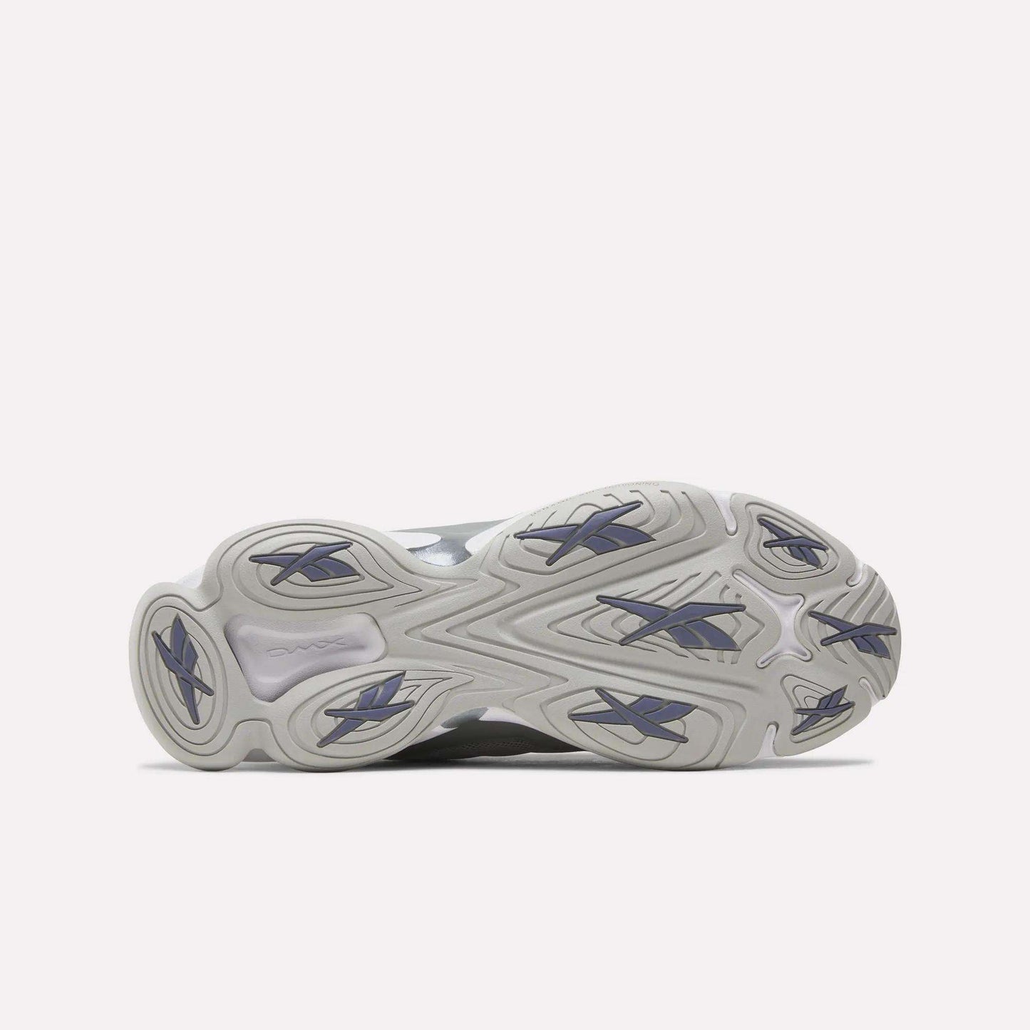 The image displays the outsole of the Reebok DMX Series 3000 Shoes, showcasing a wavy, textured light gray pattern with dark blue rubber traction accents against a white background. These shoes are engineered for comfort and enhanced grip, featuring innovative DMX moving air technology.