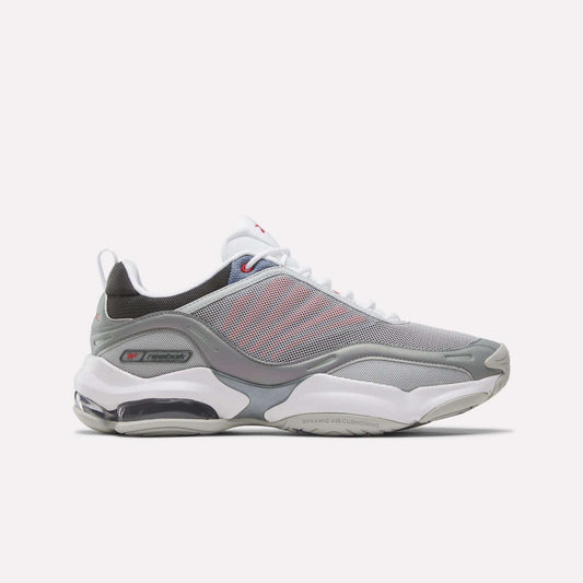 The Reebok DMX Series 3000 Shoes in Grey/White/Red feature mesh panels, white laces, a visible air-cushioned sole with DMX moving air technology for enhanced comfort, and subtle red accents. They are displayed on a plain white background.