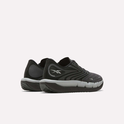 A pair of Reebok Men's FloatZig Tread Running Shoes in black and gray with white soles and a cushioned midsole are placed side by side on a light background—ideal for treadmill workouts.