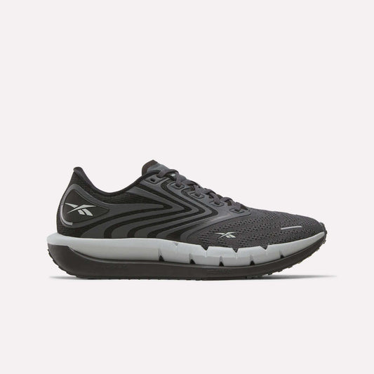 The Reebok Men's FloatZig Tread Running Shoes in black and gray feature a mesh upper, lace-up closure, thick cushioned midsole for comfort during treadmill workouts, and display the Reebok logo on the heel and side.