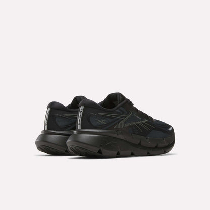 A pair of Reebok Men's FloatZig Double Running Shoes in black, cushioned with chunky soles and reflective heel details, shown from the back and side on a plain white background.