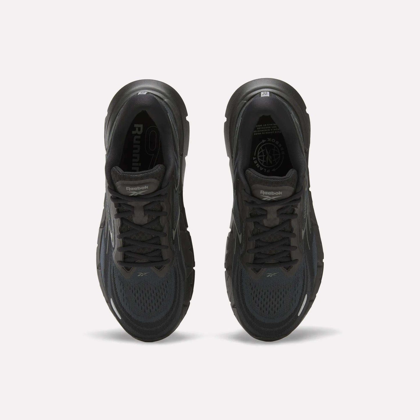 Top view of a pair of Reebok Men's FloatZig Double Running Shoes in black, featuring cushioned soles, dark laces, and mesh uppers, displayed side by side on a plain white background.