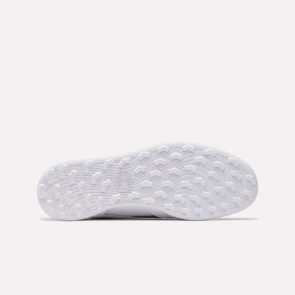 The image shows the white, textured sole of the Reebok Men's Club C Revenge Golf Shoes from below, with various grip patterns and a star-shaped design—highlighting its spikeless outsole for versatile traction.