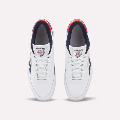 A top view of Reebok Men's Club C Revenge Golf Shoes in white with navy accents, red heel detail, and a spikeless outsole. Water-resistant shoes feature the Reebok logo and a basketball graphic on each tongue.