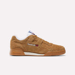 A single Reebok Workout Plus Shoe in brown suede with a gum sole, white lining, and side Reebok logo is displayed in profile against a plain light background, capturing the classic '80s fitness vibe.