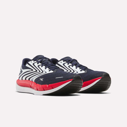 Men's Reebok FloatZig Tread Running Shoes in navy blue with white zig-zag patterns, red midsoles, and black outsoles, ideal for treadmill workouts, shown against a plain white background.