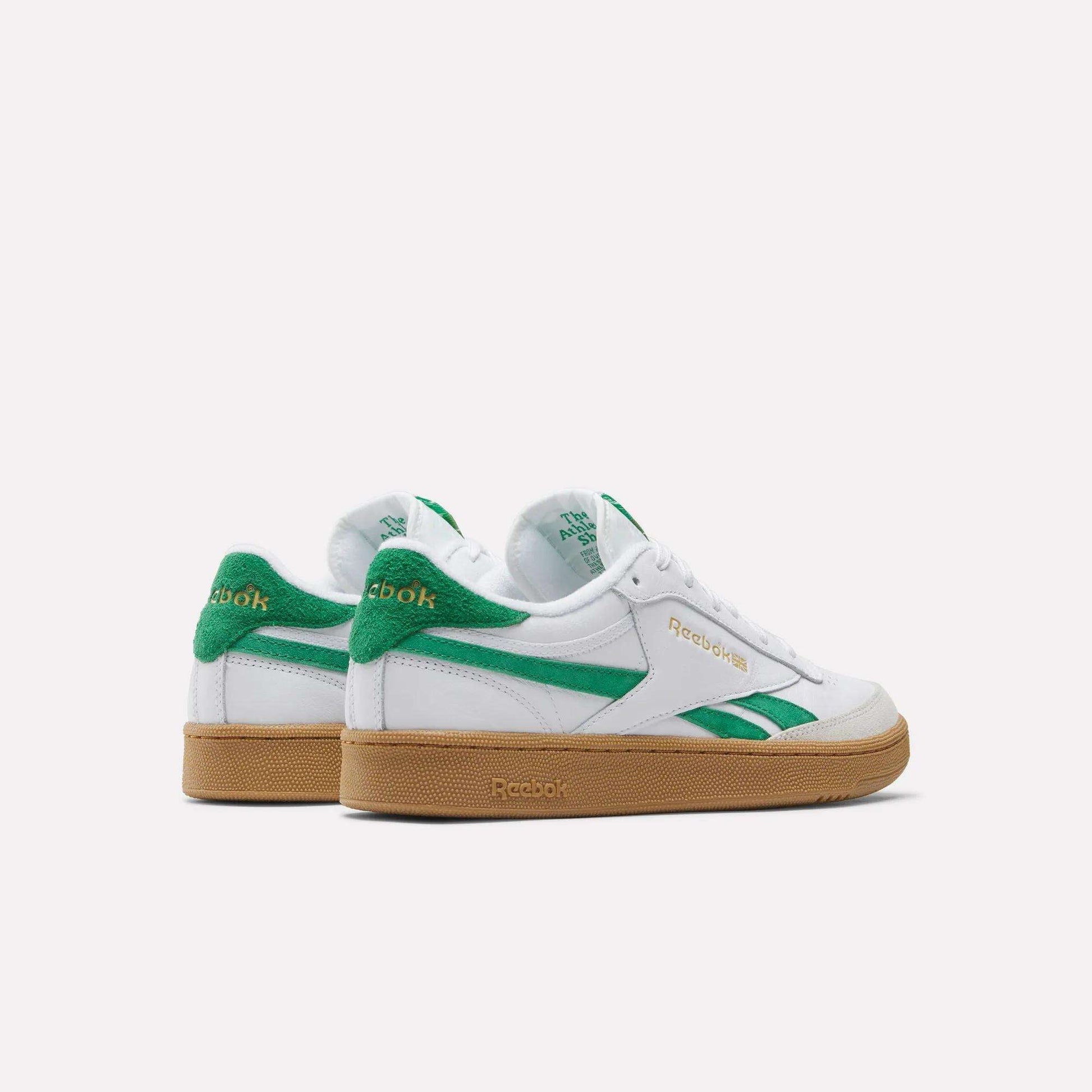 Reebok Men's Club C Revenge Vintage Shoes shown from the back and side, featuring white leather uppers, green accents, and gum rubber soles, displayed on a plain white background for a clean heritage look.