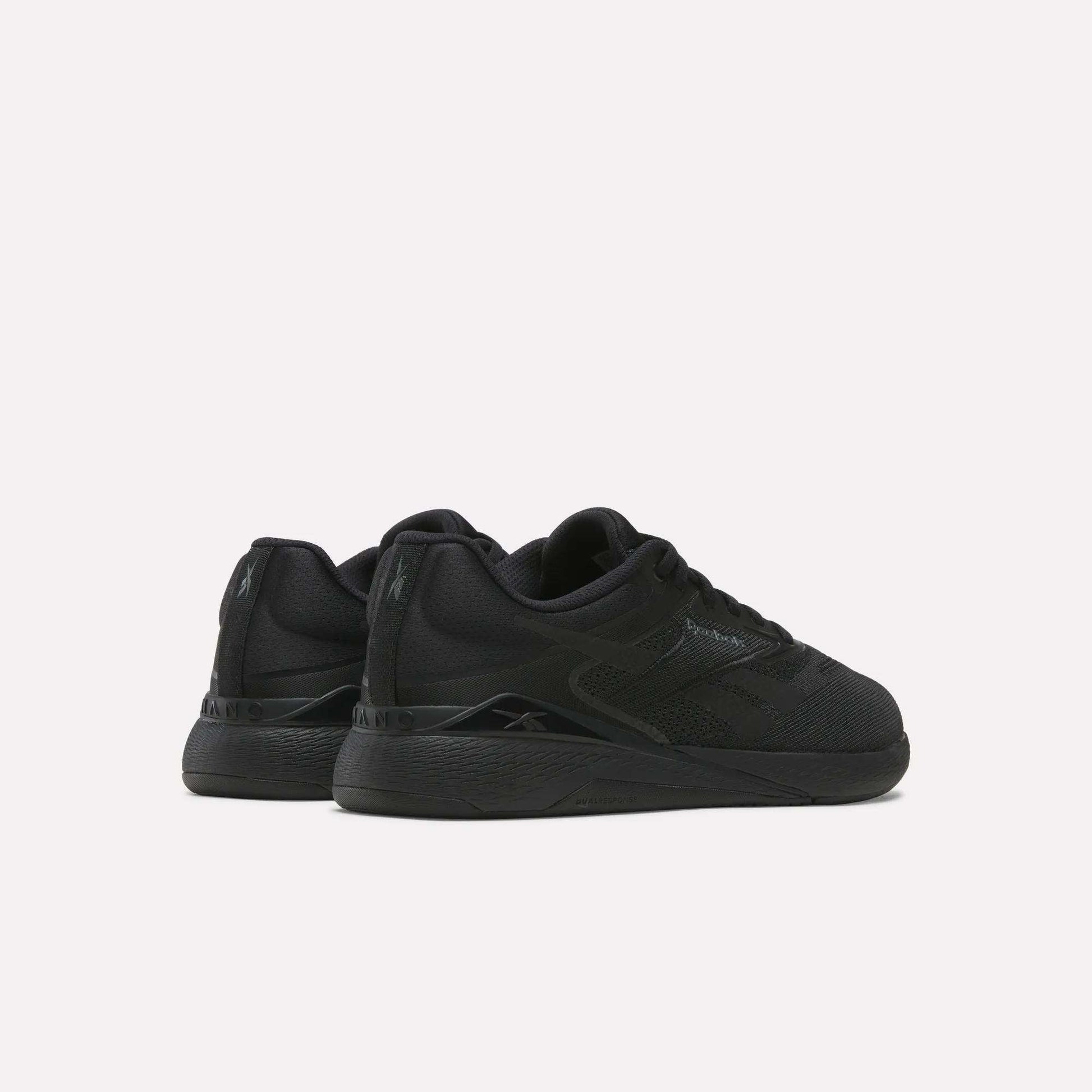A pair of black Reebok Nano X5 Training Shoes with textured soles and subtle branding, shown side by side on a plain white background from a rear-side angle—ideal training shoes for comfort.