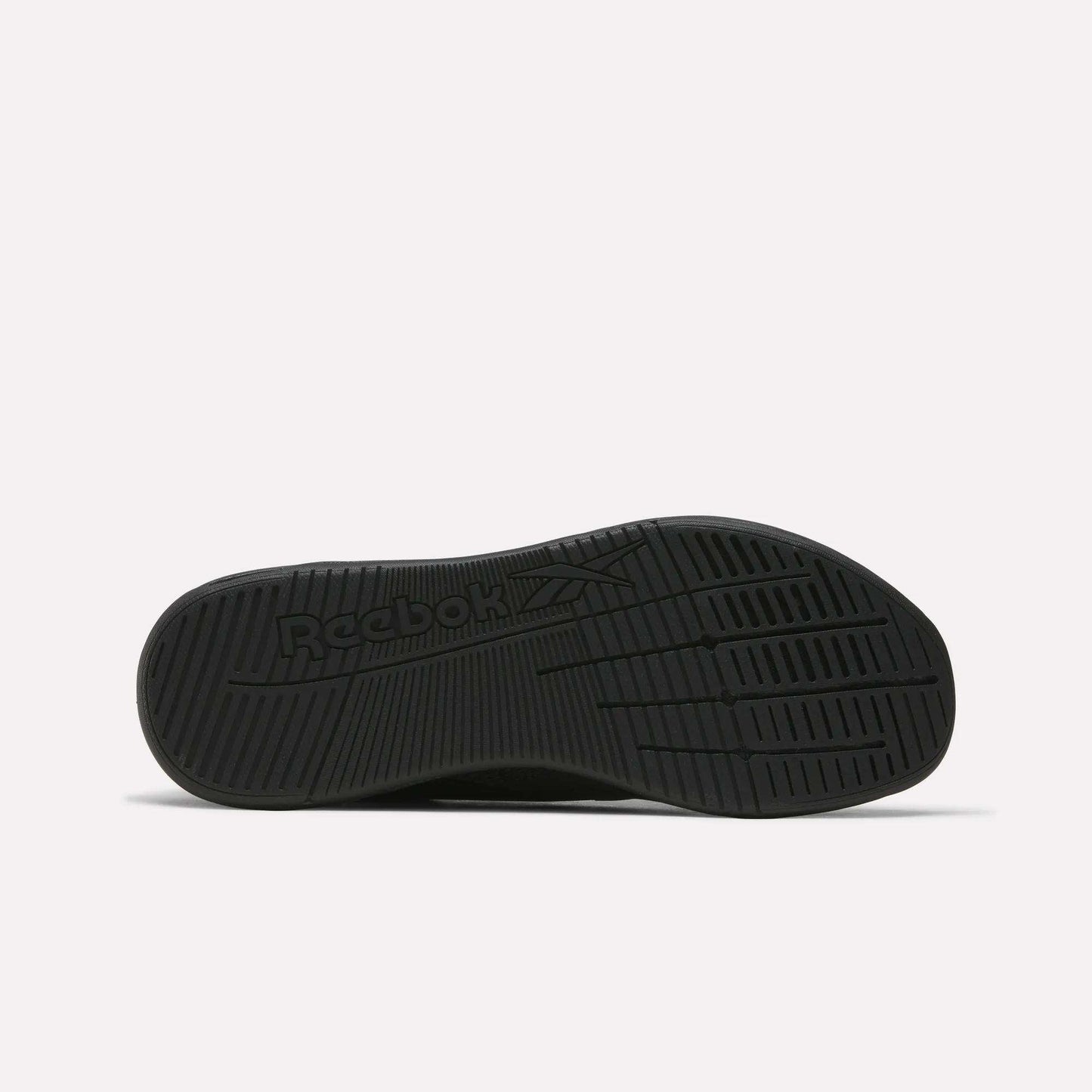 The image displays the black rubber sole of Reebok Nano X5 Training Shoes from the bottom, featuring textured grip patterns and an embossed logo, emphasizing comfort and support. The background is plain white.