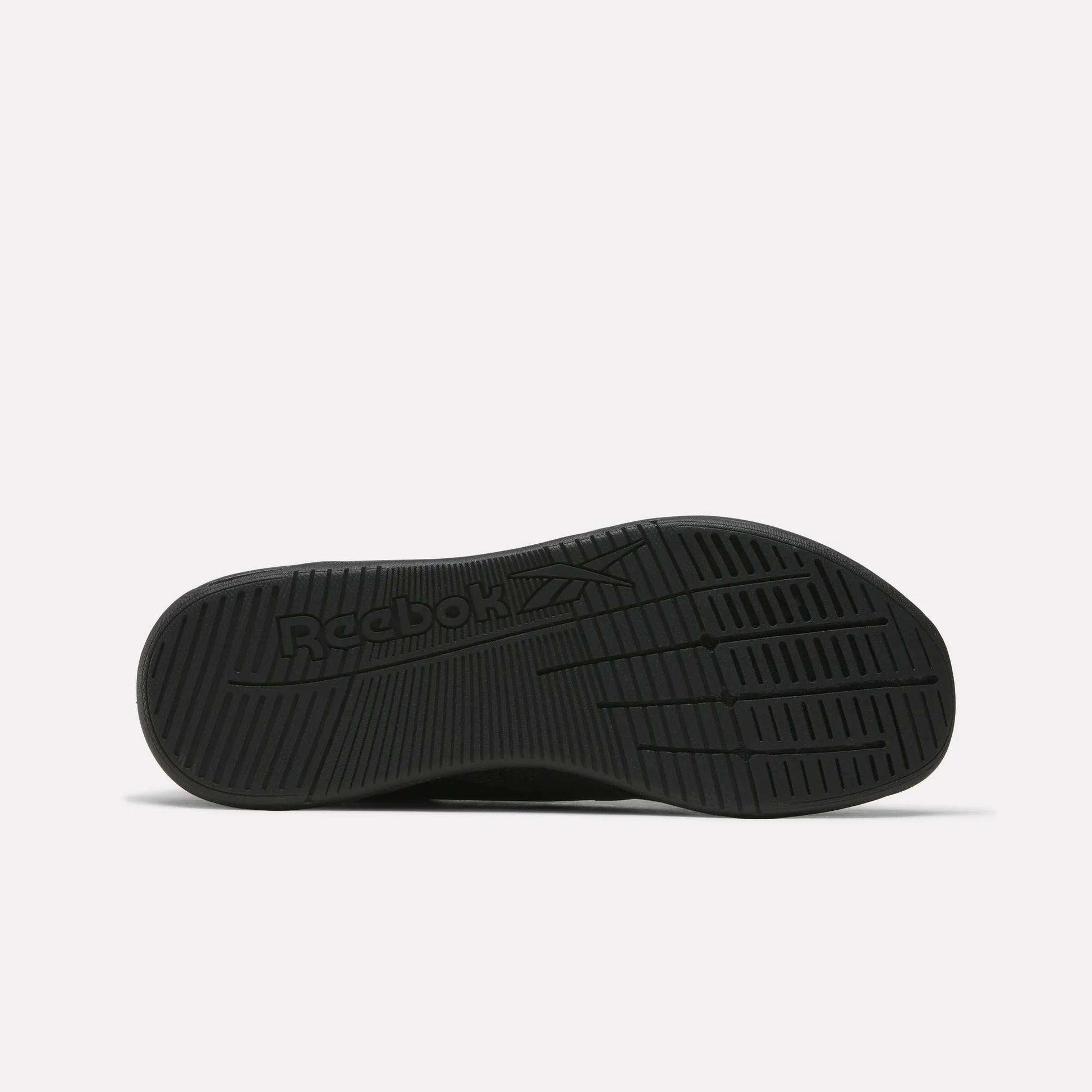 The image displays the black rubber sole of Reebok Nano X5 Training Shoes from the bottom, featuring textured grip patterns and an embossed logo, emphasizing comfort and support. The background is plain white.