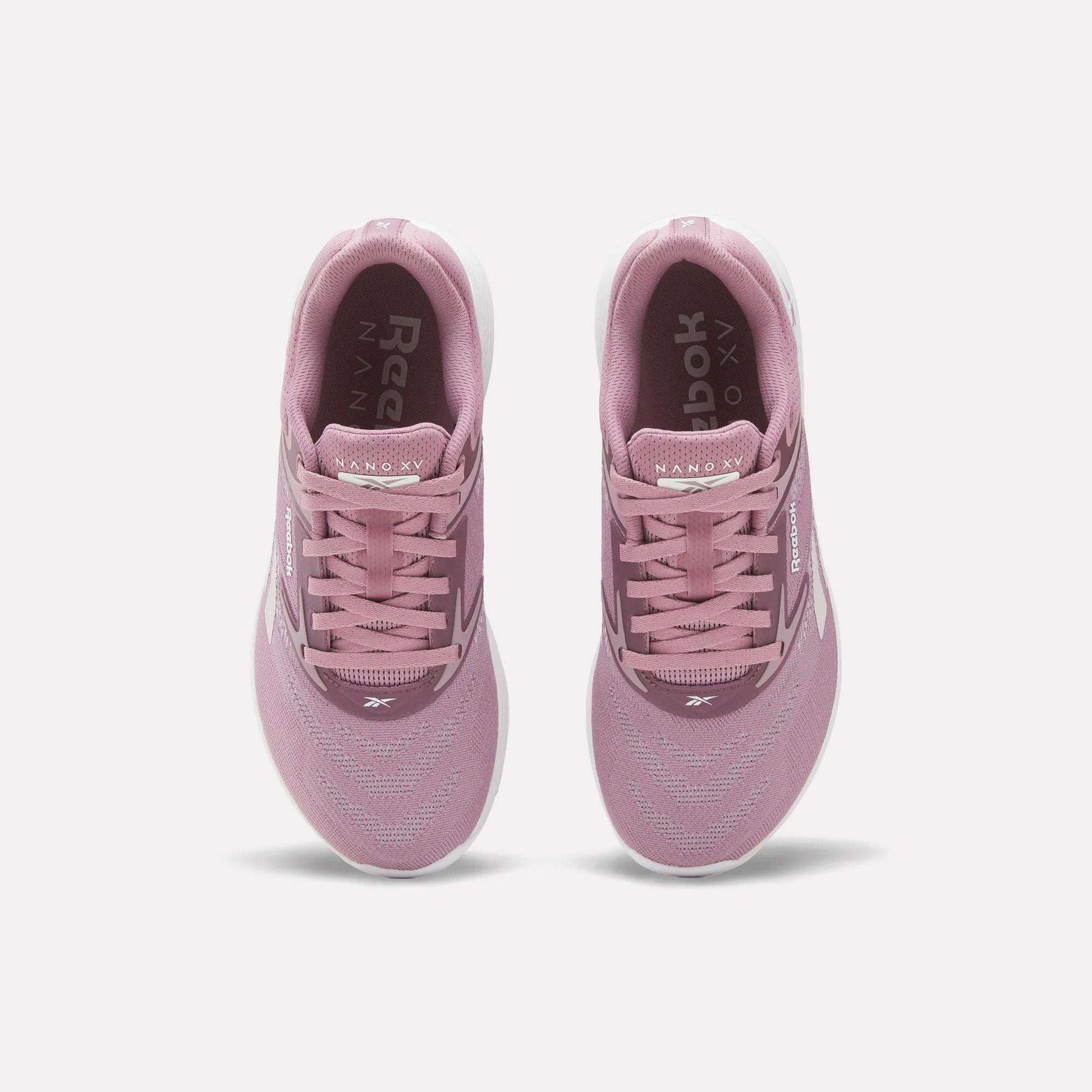 A pair of Reebok Nano X5 Women's Training Shoes in pink, viewed from above with visible laces, mesh upper, dual-density midsole, and white soles on a plain white background—ideal for stylish support during training.