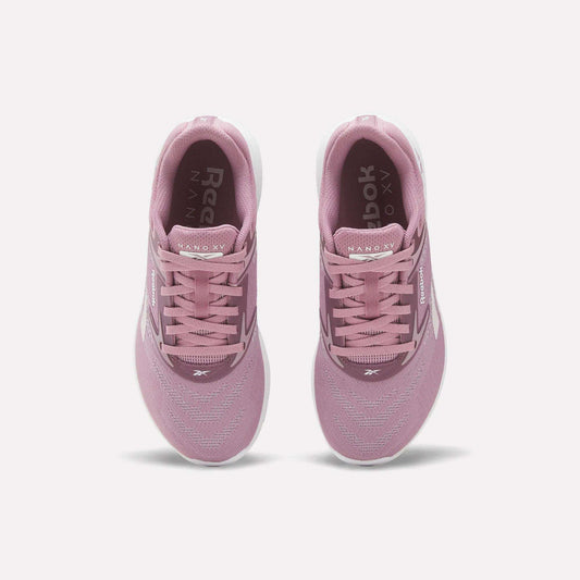 A pair of Reebok Nano X5 Women's Training Shoes in pink, viewed from above with visible laces, mesh upper, dual-density midsole, and white soles on a plain white background—ideal for stylish support during training.