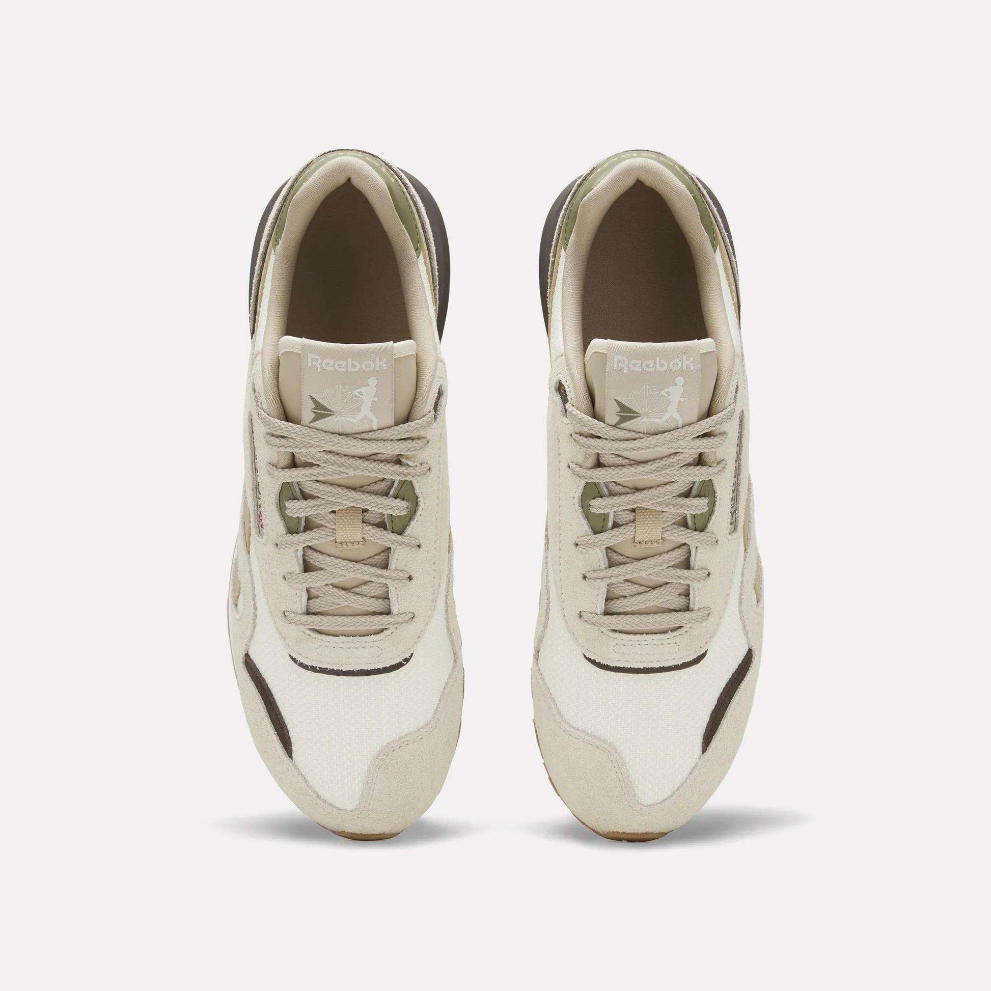 Top view of Reebok Men's Classic Nylon 89 Shoes with a beige and white suede upper, light brown and olive green accents, shown side by side on a plain white background.
