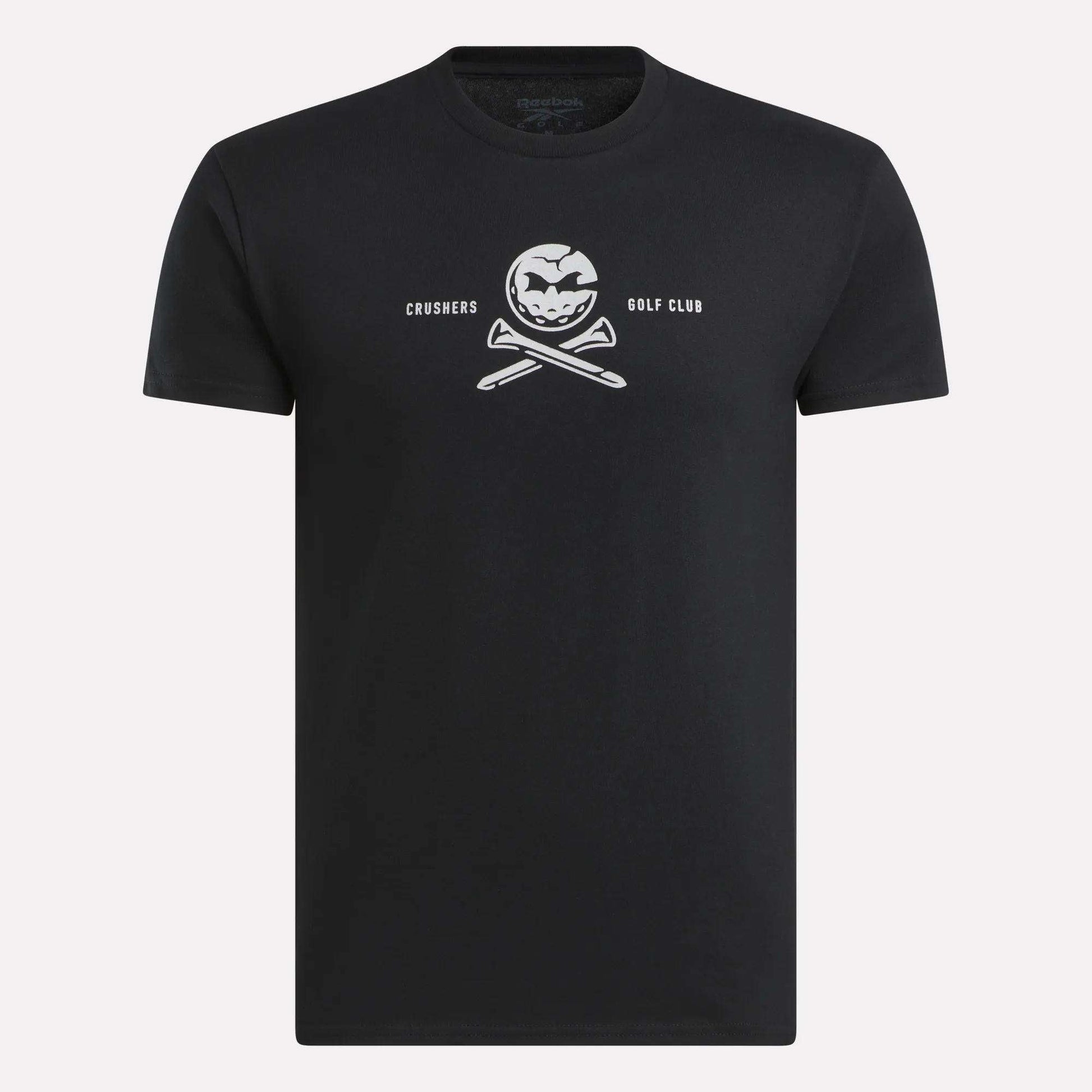 The Men’s Crushers Tee by Reebok features a bold white skull-like logo with crossed golf clubs and “CRUSHERS GOLF CLUB” text centered on the chest, inspired by Bryson DeChambeau.