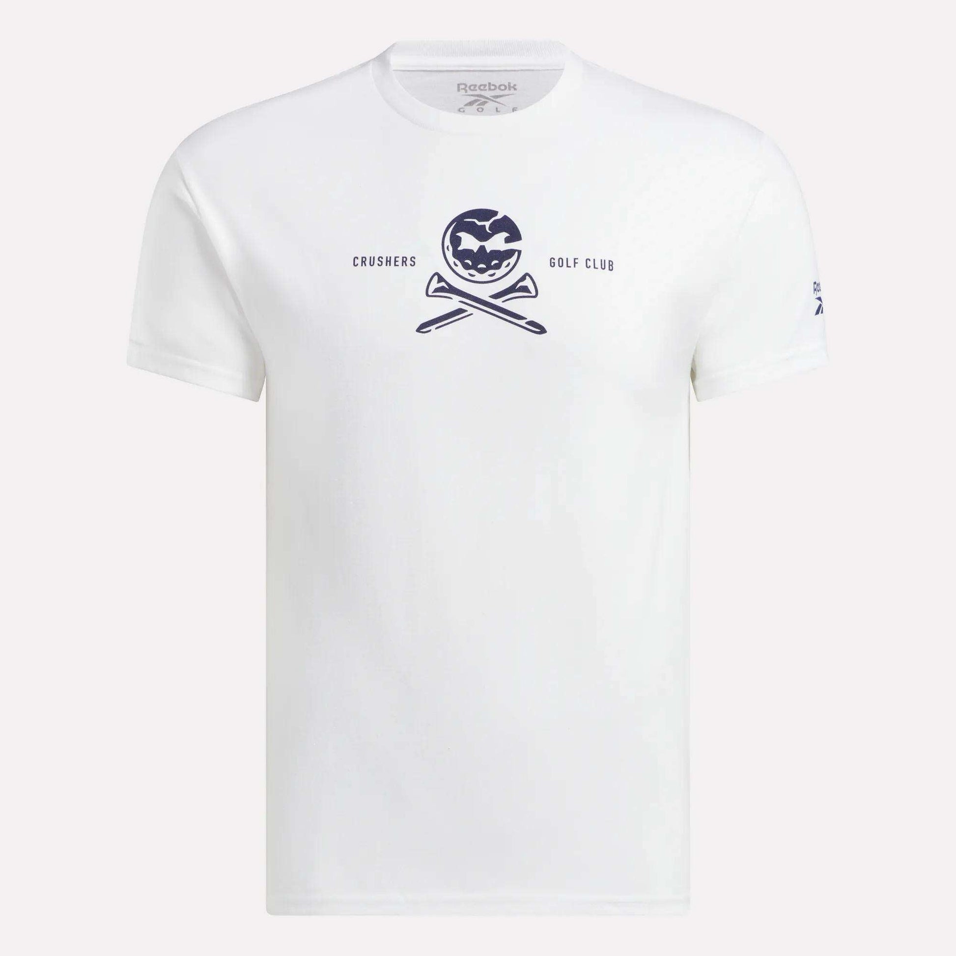 The Men's Crushers Tee by Reebok is a white shirt featuring a navy pumpkin graphic above crossed golf clubs and the text "CRUSHERS GOLF CLUB," inspired by Bryson DeChambeau's passion for the Crushers.
