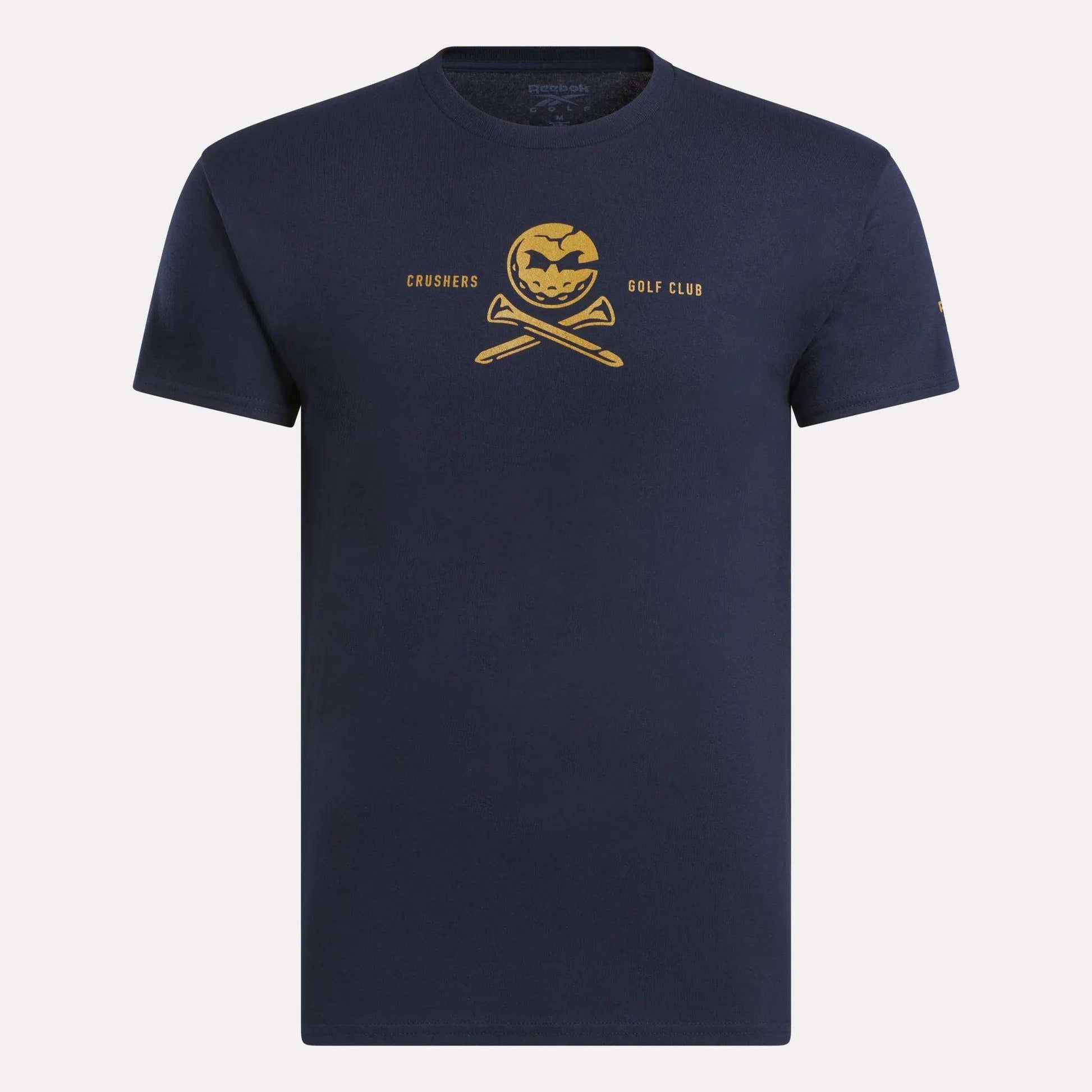 The Men's Crushers Tee by Reebok features a yellow pumpkin skull over crossed golf clubs with "Crushers Golf Club" text, offering a bold navy blue style inspired by Bryson DeChambeau.
